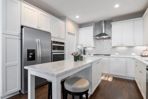 Free Spacious, elegant kitchen featuring stainless steel appliances and marble countertops. Stock Photo