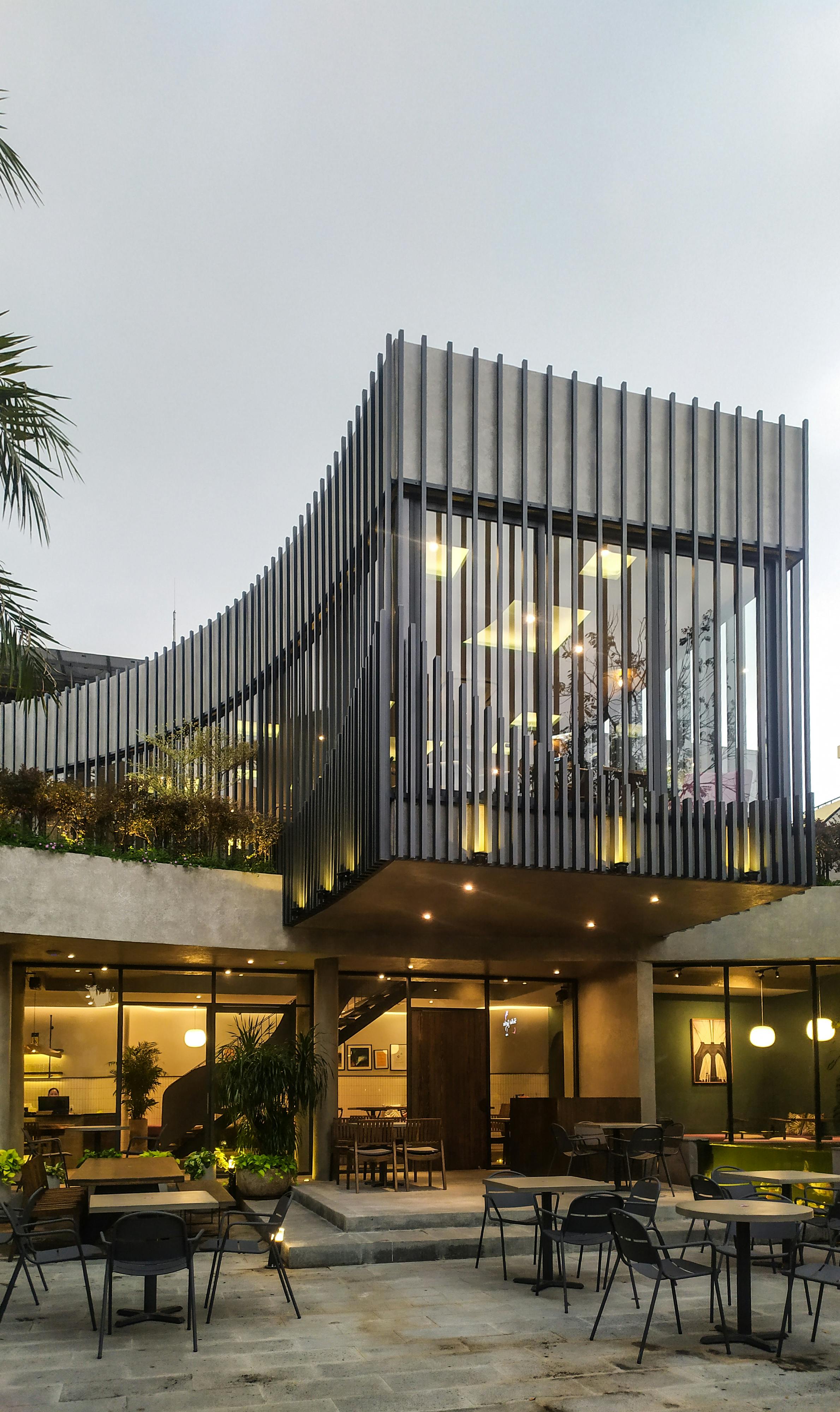 Modern architectural design of a restaurant in Bình Dương, Vietnam with outdoor seating.