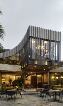 Modern architectural design of a restaurant in Bình Dương, Vietnam with outdoor seating.