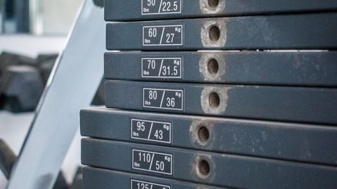 Close-up view of gym weight stack with multiple weight options for exercise equipment.