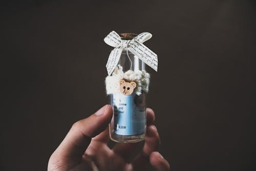 Hand Holding Decorated Bottle