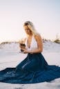 Woman in White Tank Top And Blue Skirt Shuffling Some Tarot Cards