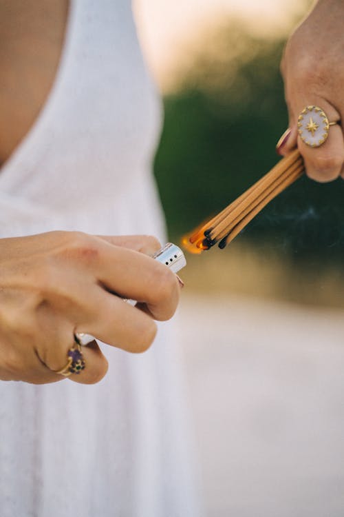 Woman Lighting Matchsticks