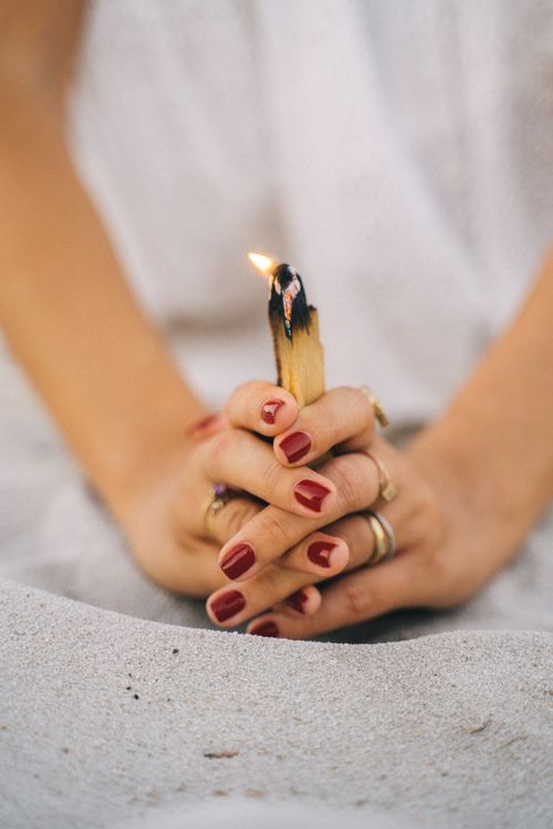 Free Close-up of hands with palo santo stick, symbolizing relaxation and mindfulness. Stock Photo