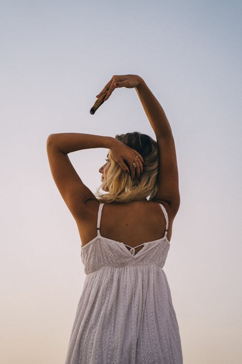 Free Back View of a Woman Holding Palo Santo over her Head Stock Photo