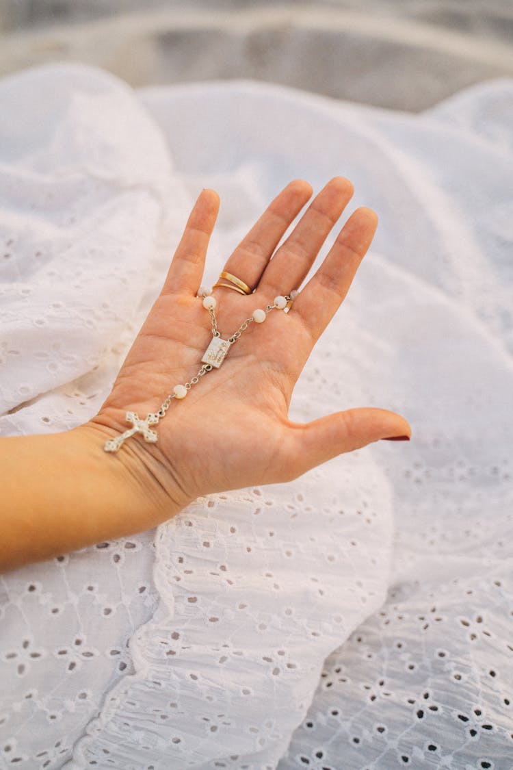 Close-up Of A Hand Holding A Rosary