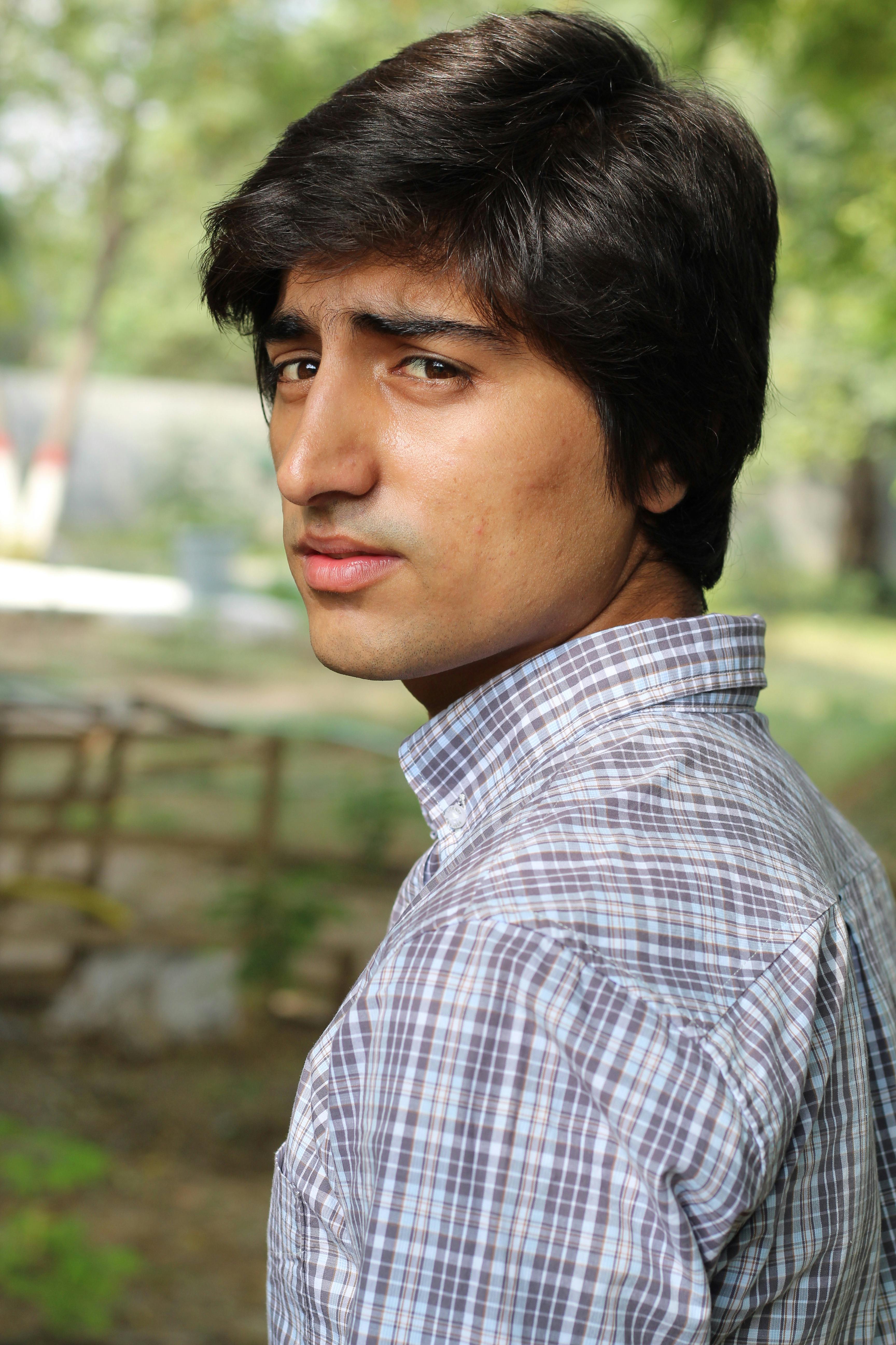 Portrait of a man outdoors, looking back with natural background