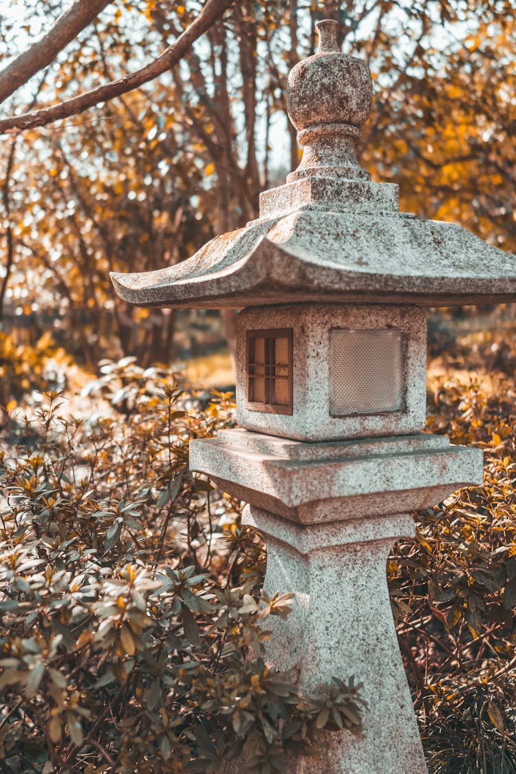 Japanese Style Stone Statue In A Garden 