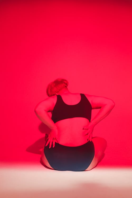 A Woman in Black Tank Top Sitting on the Floor