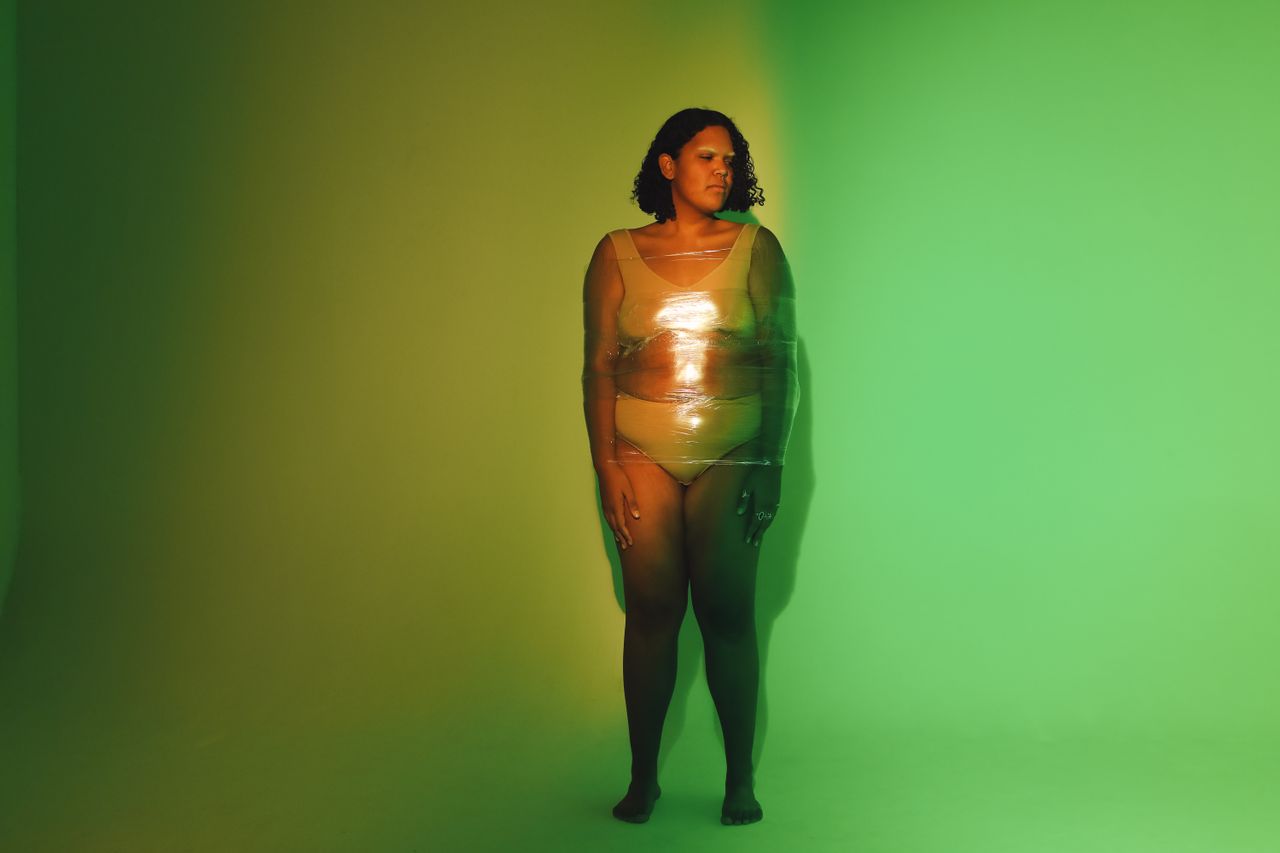 artistic portrait of plus size woman in studio with bold lighting emph