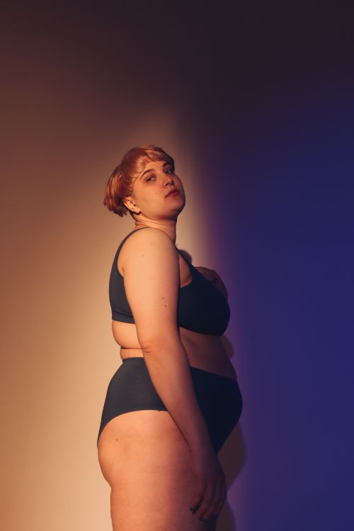 Free Artistic studio shoot of a confident plus size woman embracing body positivity. Stock Photo