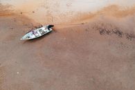 Wet sandy shore of sea with boat