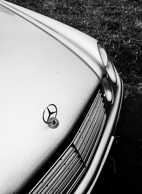 Free Elegant shot of a Mercedes W123 hood with raindrops, captured in black and white. Stock Photo