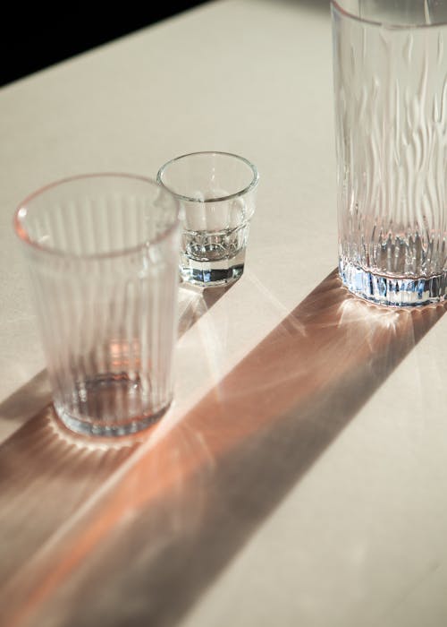 Clear Drinking Glasses on a White Surface
