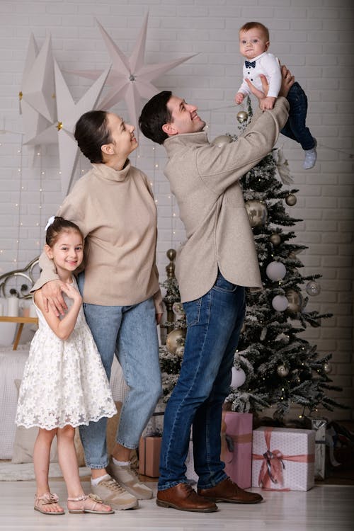 Happy Family with Children near Fir Tree