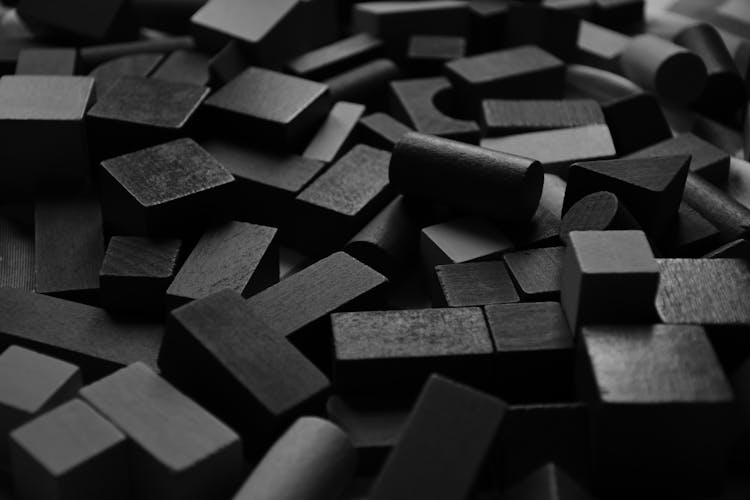 Close-up Of Pile Of Black Wooden Blocks