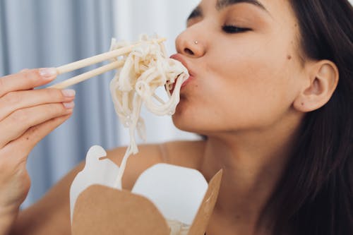 Free Woman Eating Noodles Stock Photo