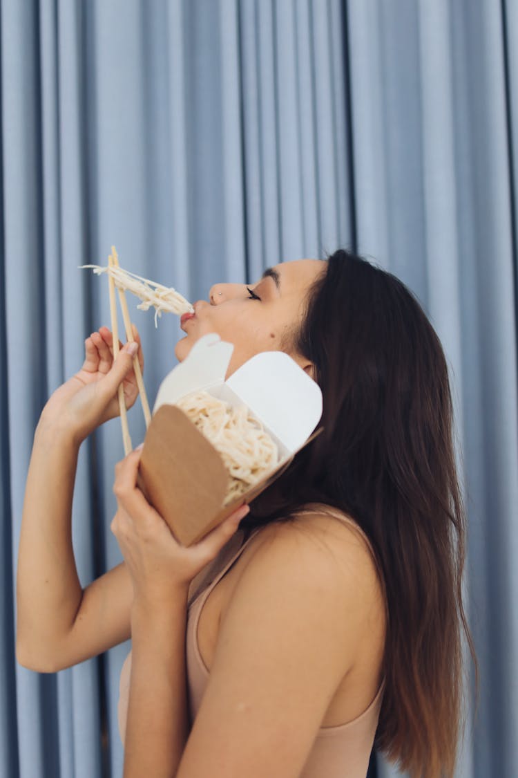 A Woman Eating Noodles