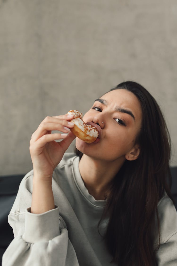 Portrait Of A Woman Eating A Donut