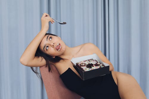 Free Photograph of a Woman Eating Cake Stock Photo