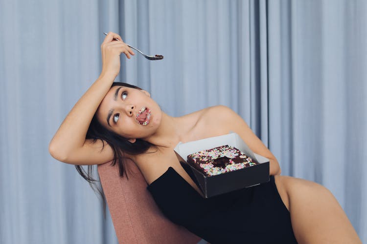 Photograph Of A Woman Eating Cake