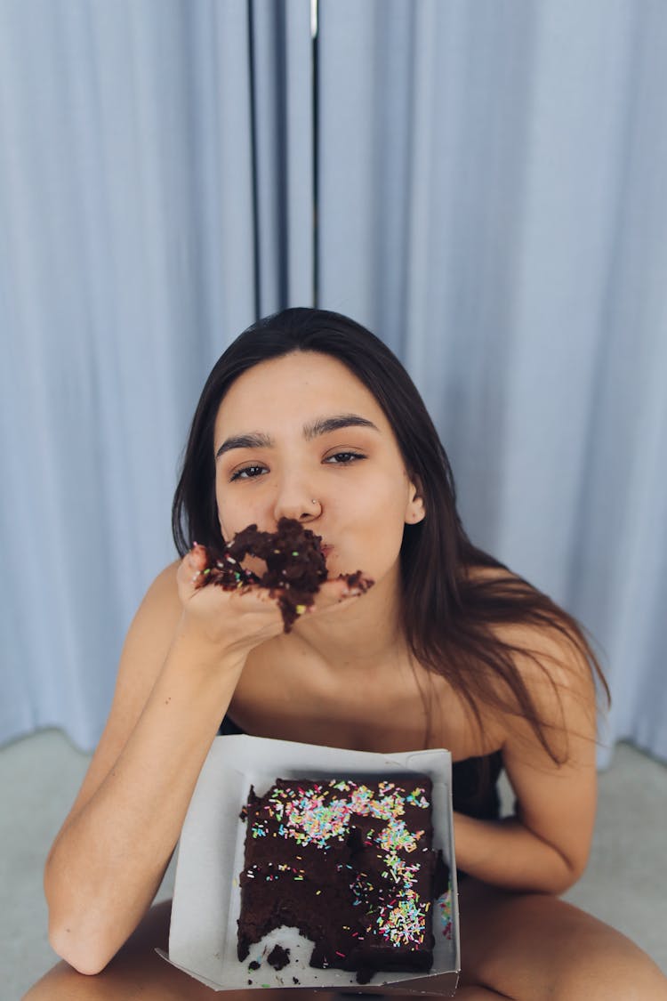 A Woman Eating Chocolate Cake