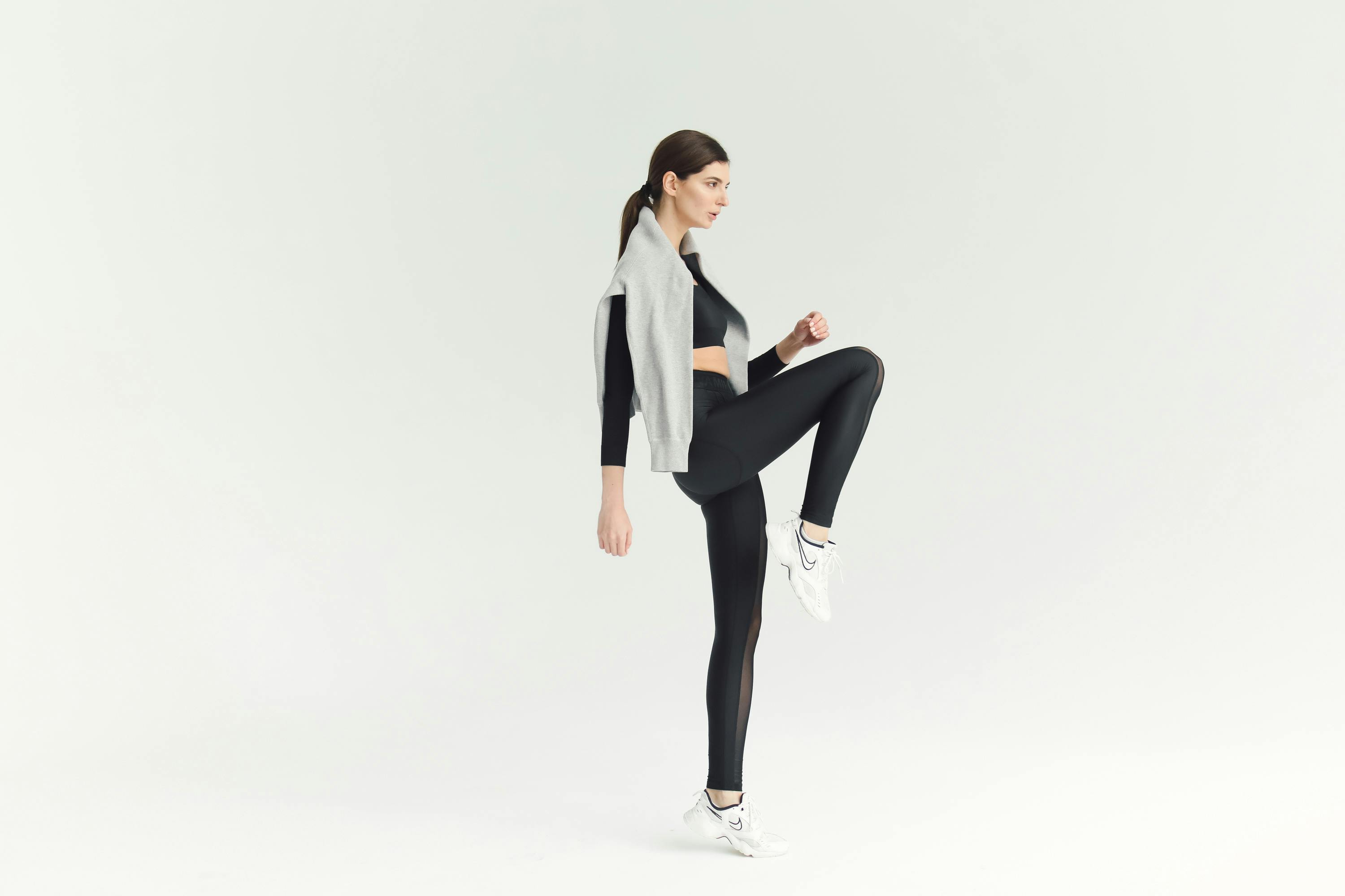 Woman Exercising with a Gray Sweater Hanging at Her Back · Free Stock Photo