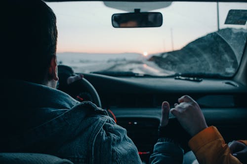 Unrecognizable couple travelling in car