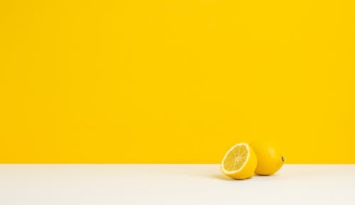Free Sliced Lemon on White Surface Stock Photo