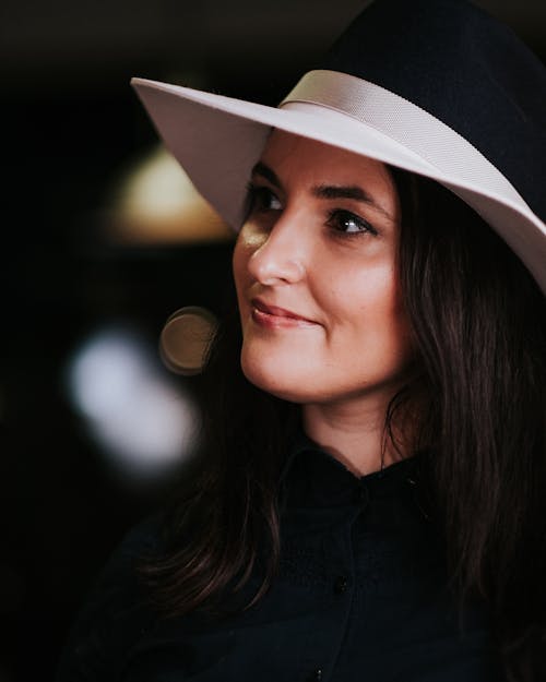 Free Woman in Black Button Up Shirt Wearing White Fedora Hat Stock Photo