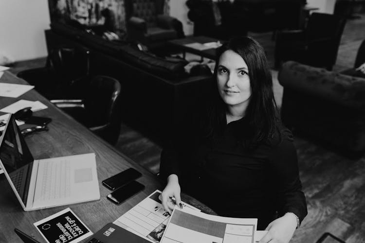 Grayscale Photo Of A Woman In The Office