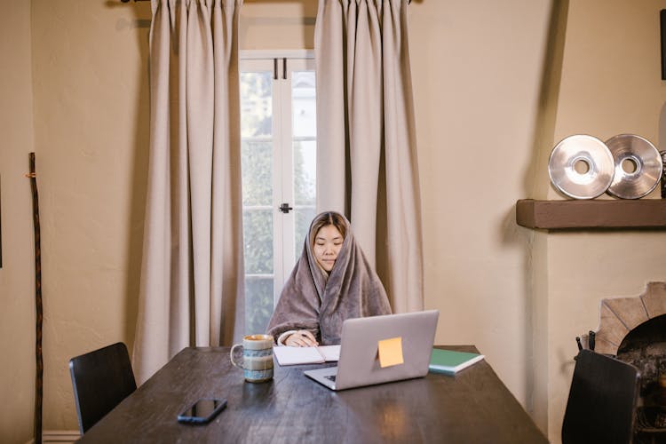 A Woman Covered With Fleece Blanket 