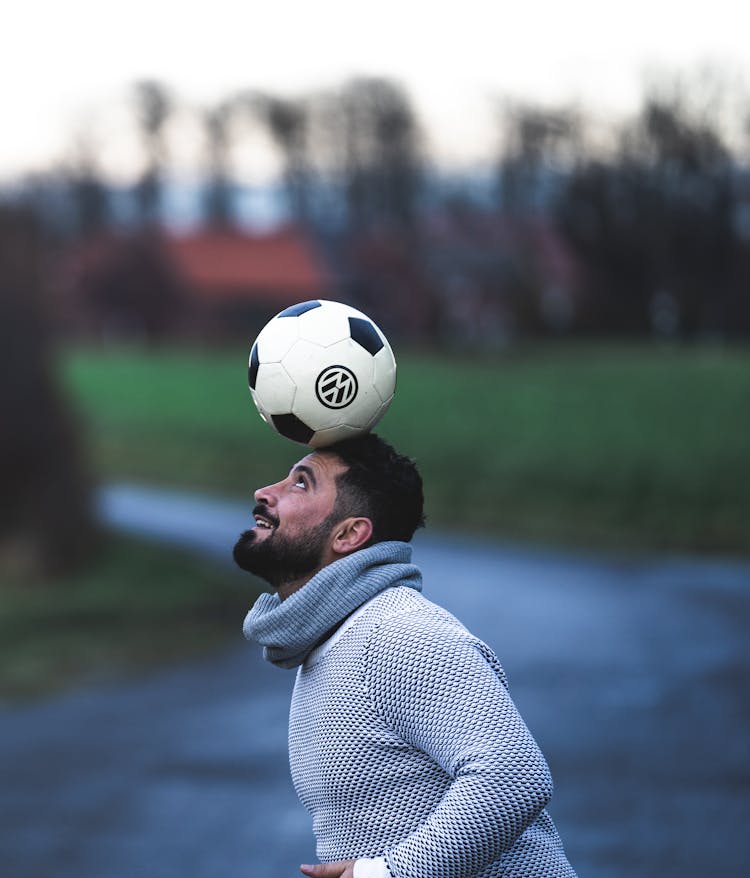 Football Player With Ball On Head