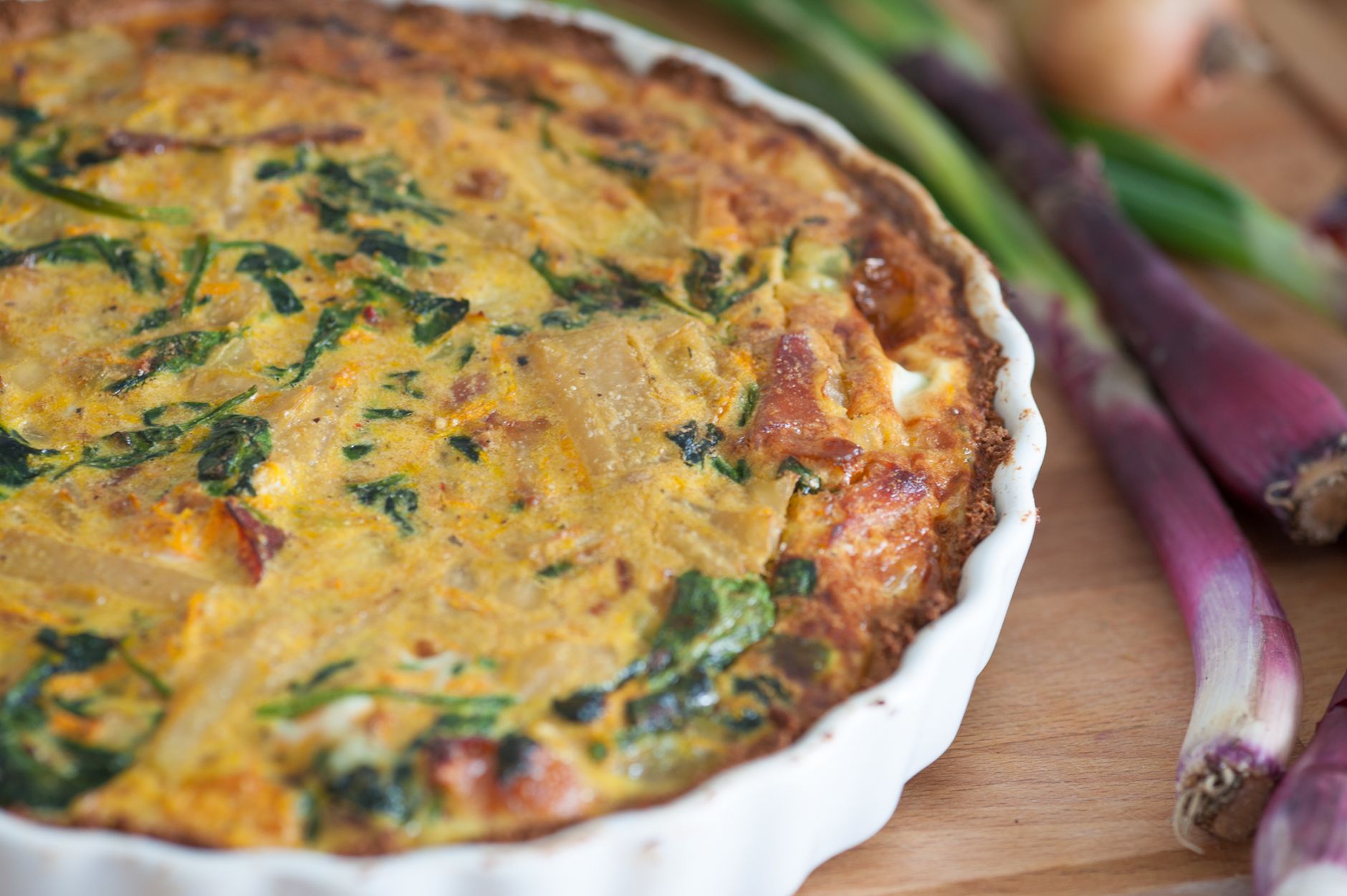 Ham and spinach quiche fresh out of the oven with golden crust