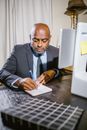 Man in Black Suit Jacket Using Macbook