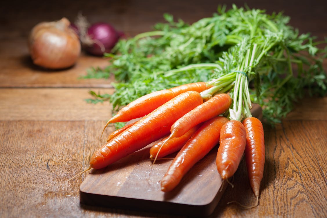 Free 8 Piece of Carrot on Brown Chopping Board Stock Photo