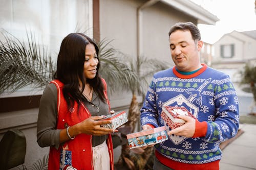 Man and Woman Holding Christmas Gifts