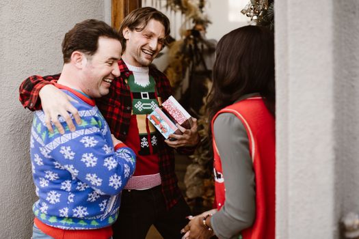 Man in Blue and Red Sweater Holding Red and White Plastic Cup