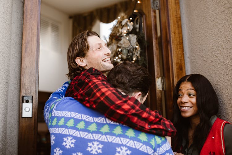 Couple Entering House With Christmas Decoration 