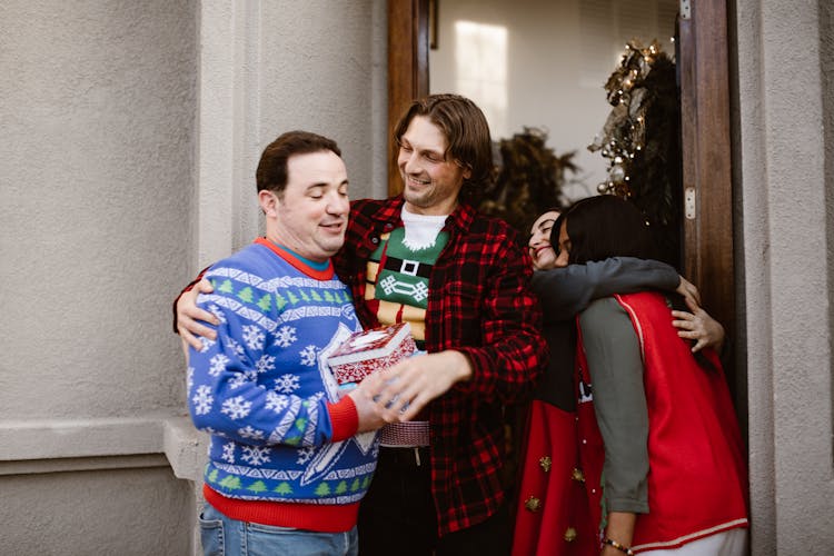 Happy Men Wearing Ugly Christmas Sweaters