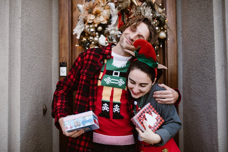 A Happy Couple Holding Gifts 