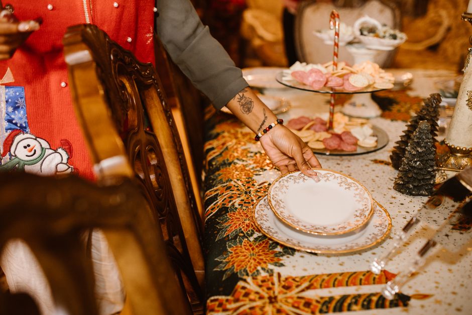 A festive holiday table setting with elegant porcelain plates and Christmas decor.