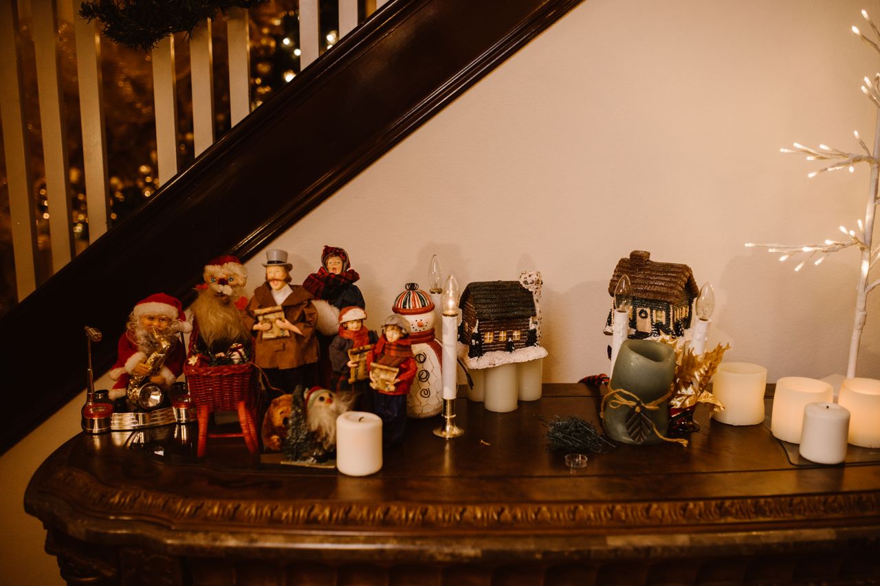 warm christmas scene with ornaments and candles on a wooden table indo