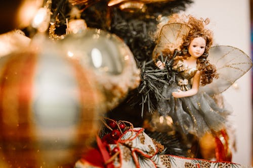 Close-Up Photo of a Christmas Baubles and a Fairy Doll