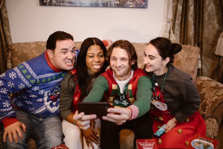 Man Sitting With Friends  Taking A Group Photo