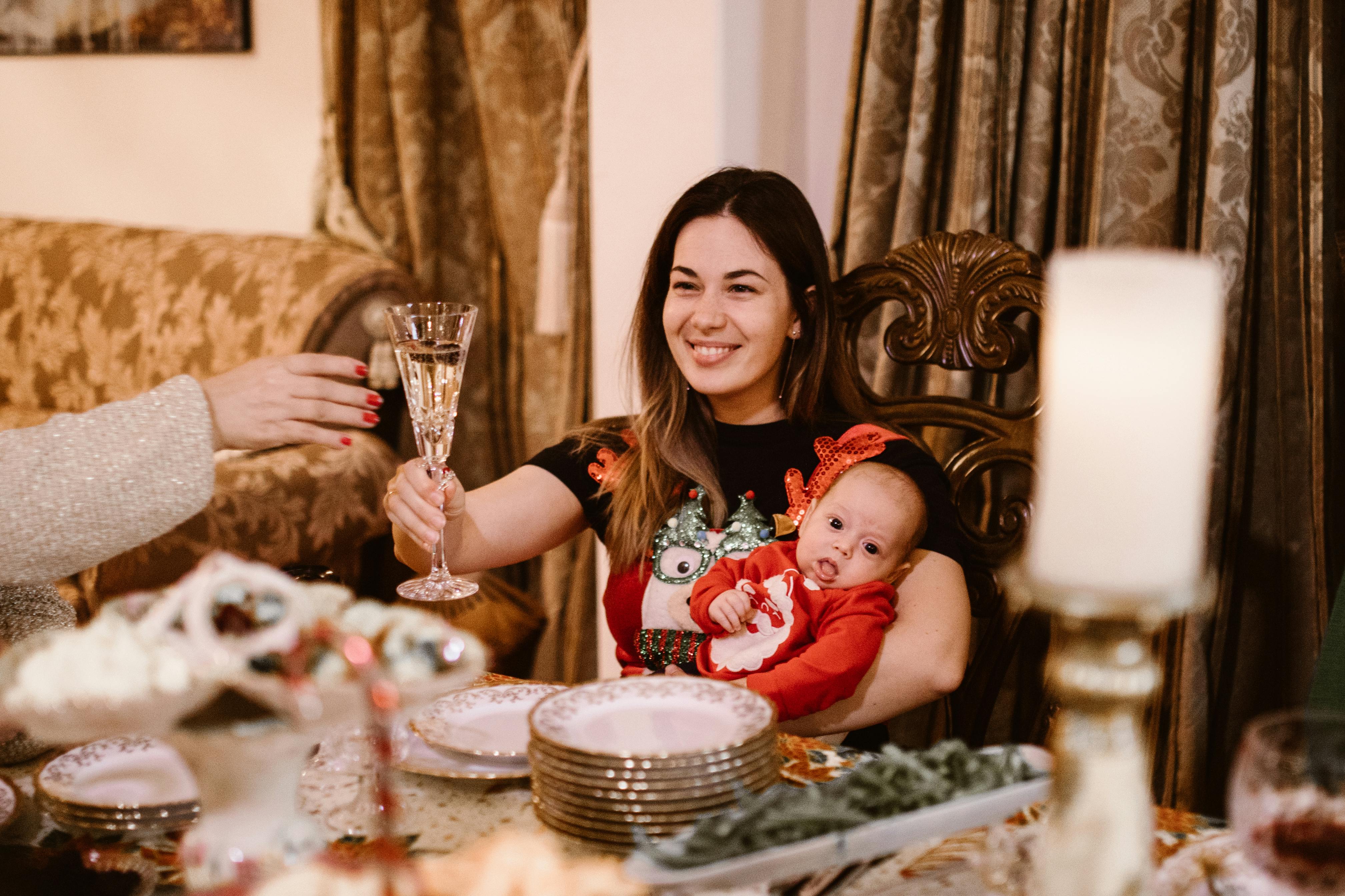 woman with a baby sitting on wooden chair smiling