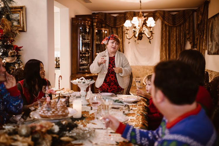 Woman Giving Speech At Family Christmas Dinner