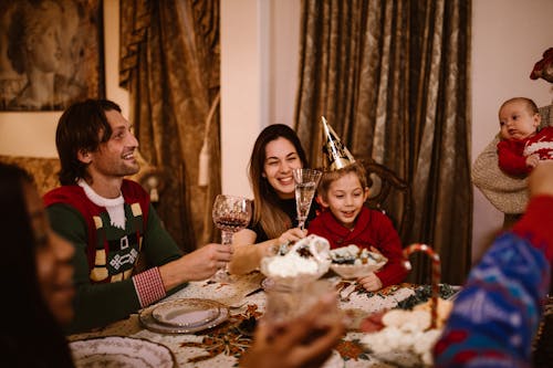 Happy Family Sitting at Dining Table 