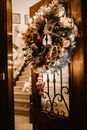 Christmas Wreath Hanging on Wooden Door with Glass Panel