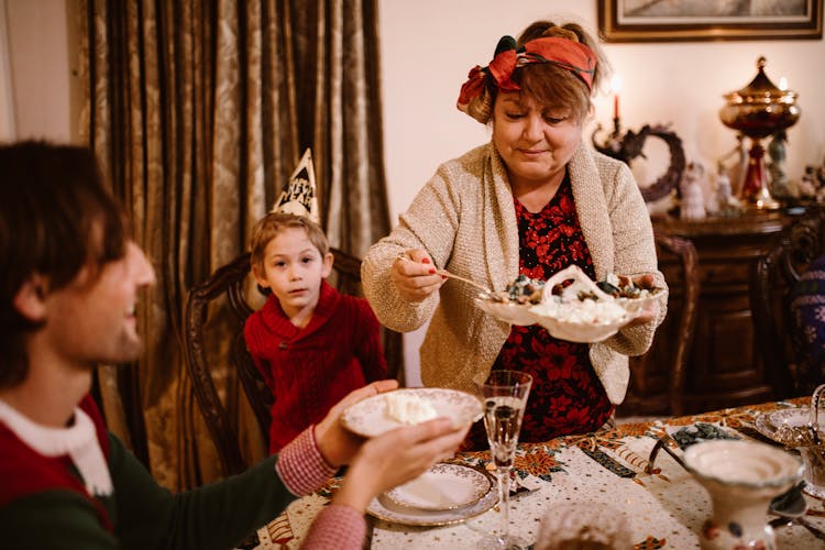 A Woman Serving Food To A Man